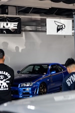 A vibrant blue-themed online marketplace interface showing various car parts sorted by brand.