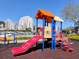 Children playing joyfully in a safe, vibrant playground within Metroplex City.