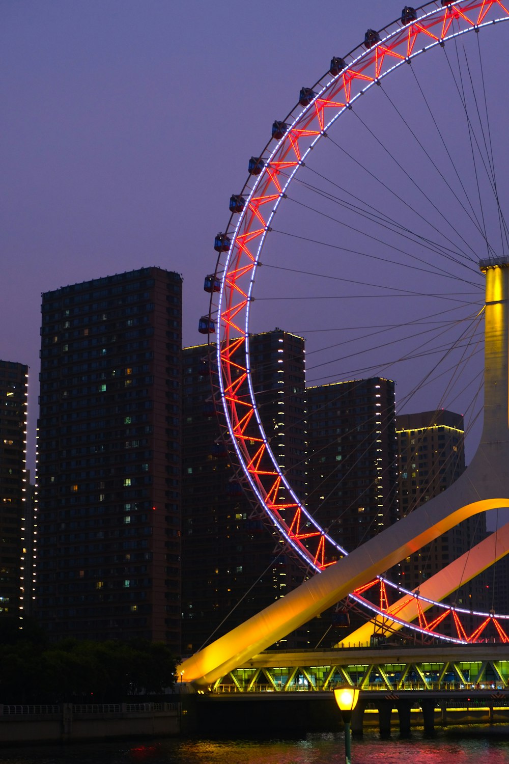 a ferris wheel in a city at night