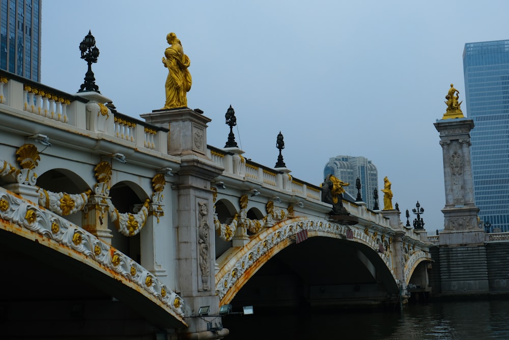 a bridge that has statues on top of it