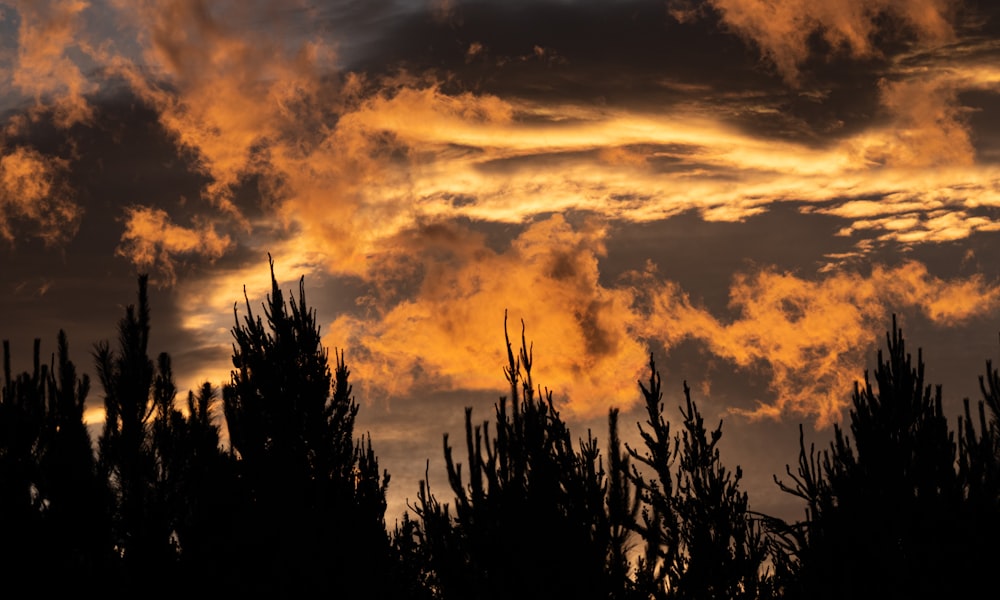 the sun is setting behind the clouds in the sky