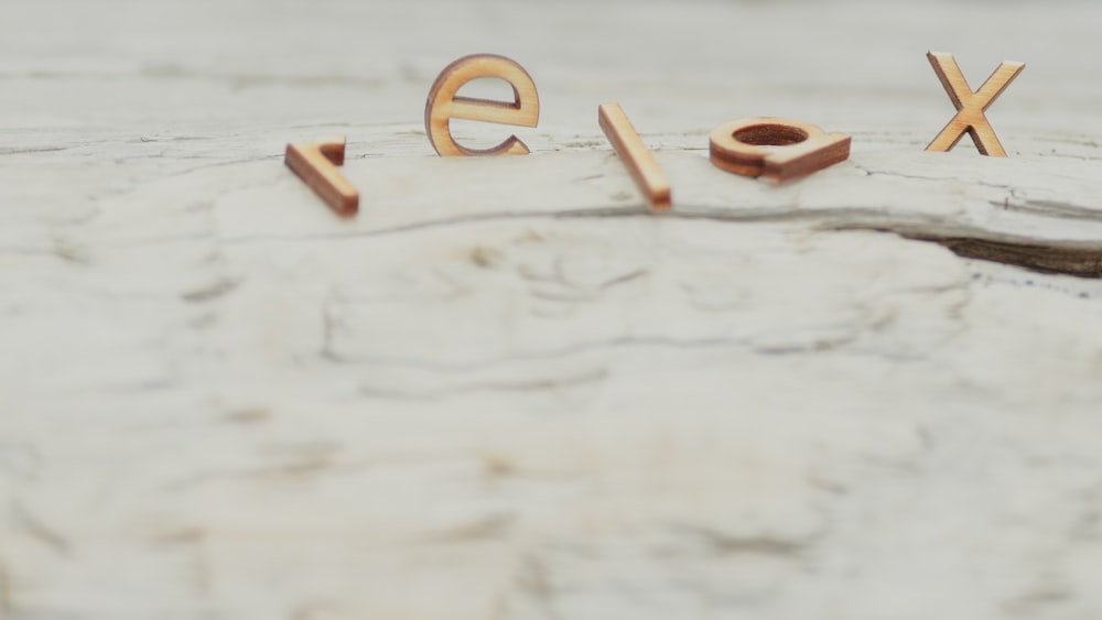 a close up of the word sex spelled with wooden letters