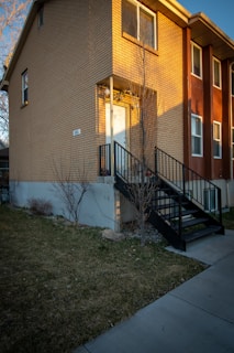 A welcoming front entrance of the Entrepreneurial Minds Academy building on Walnut Street, bathed in warm afternoon light.