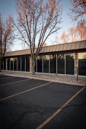 A clean, well-maintained small plaza parking lot in early morning light.