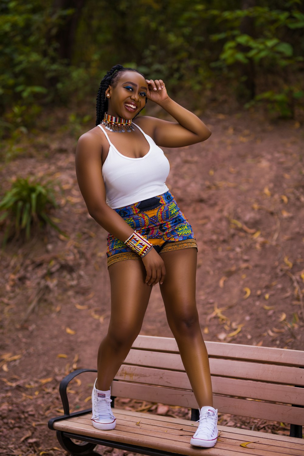 a woman posing for a picture on a bench