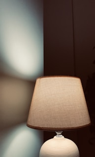 Elegant off-white 3D printed lamp casting soft shadows in a cozy room.