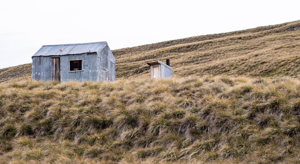 a couple of shacks sitting on top of a hill