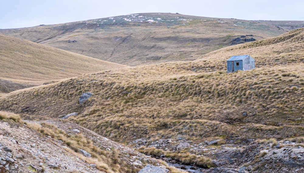 there is a small building on the side of a hill