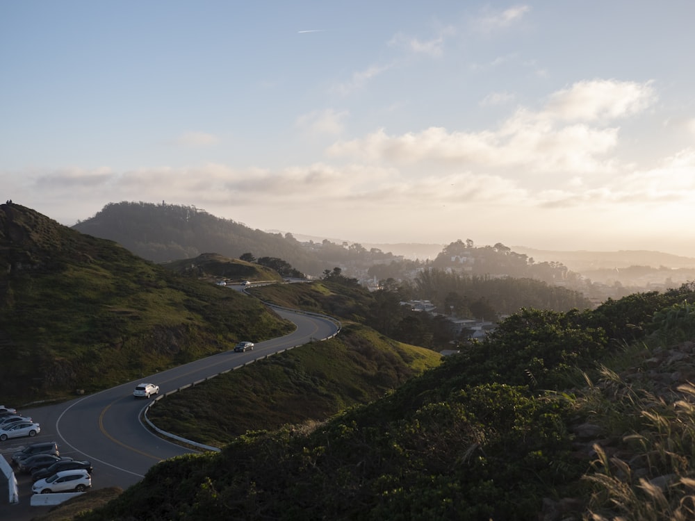 a scenic view of a winding road in the hills