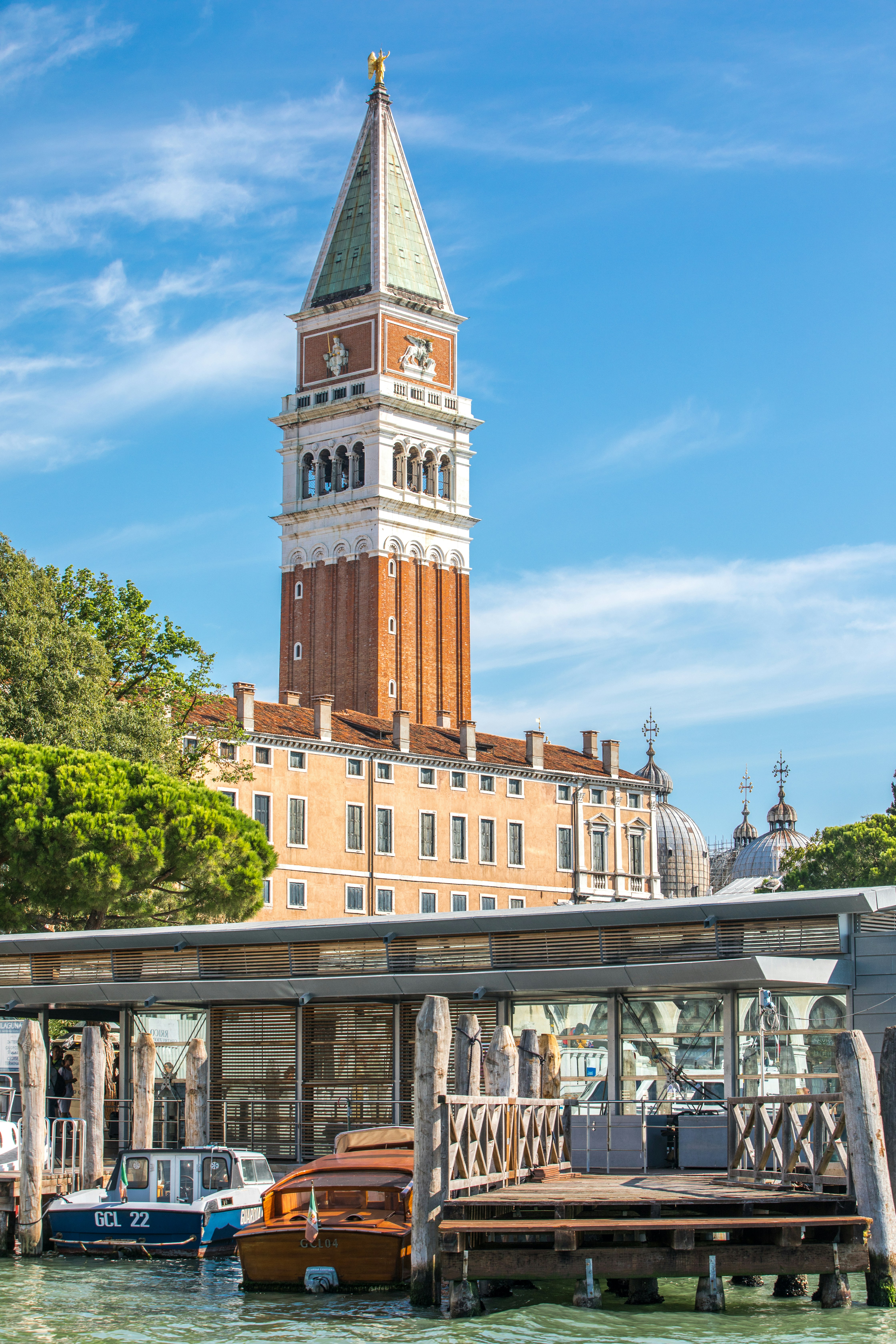 a building with a clock tower next to a dock