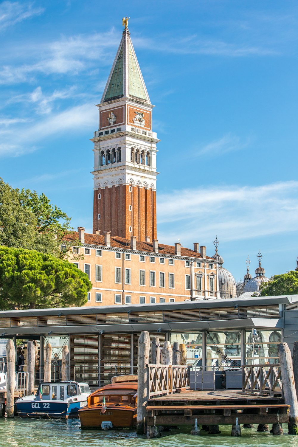 a building with a clock tower next to a dock