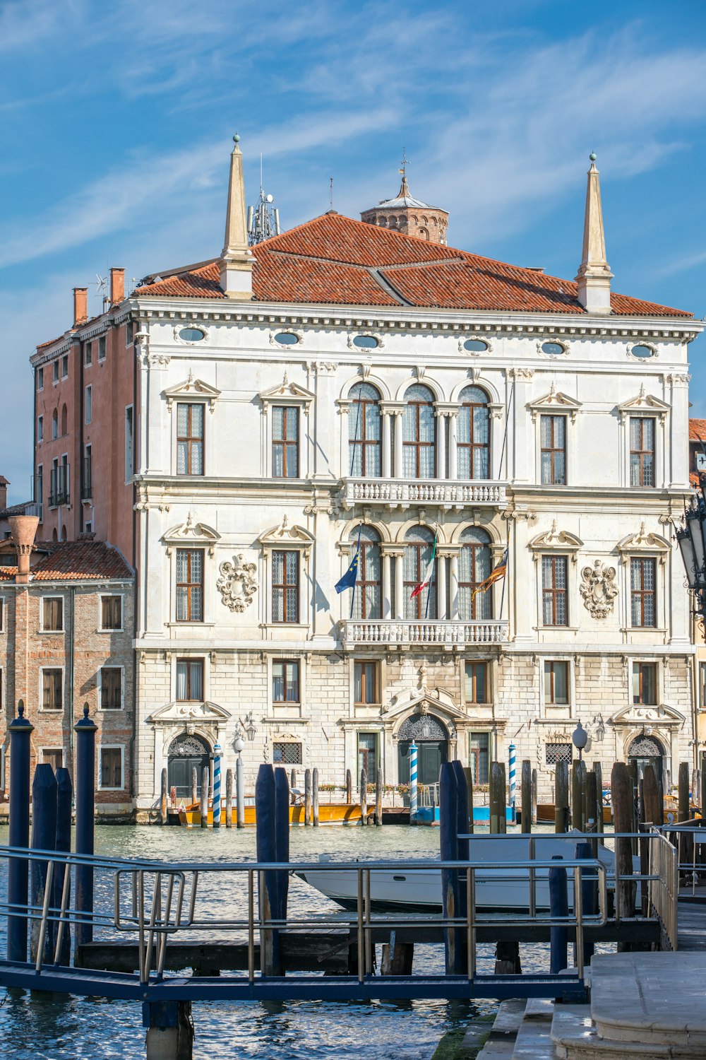 a large white building sitting next to a body of water