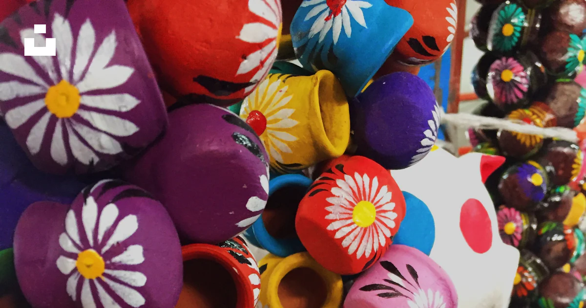 A bunch of colorful objects are hanging on a wall photo – Free Ball ...