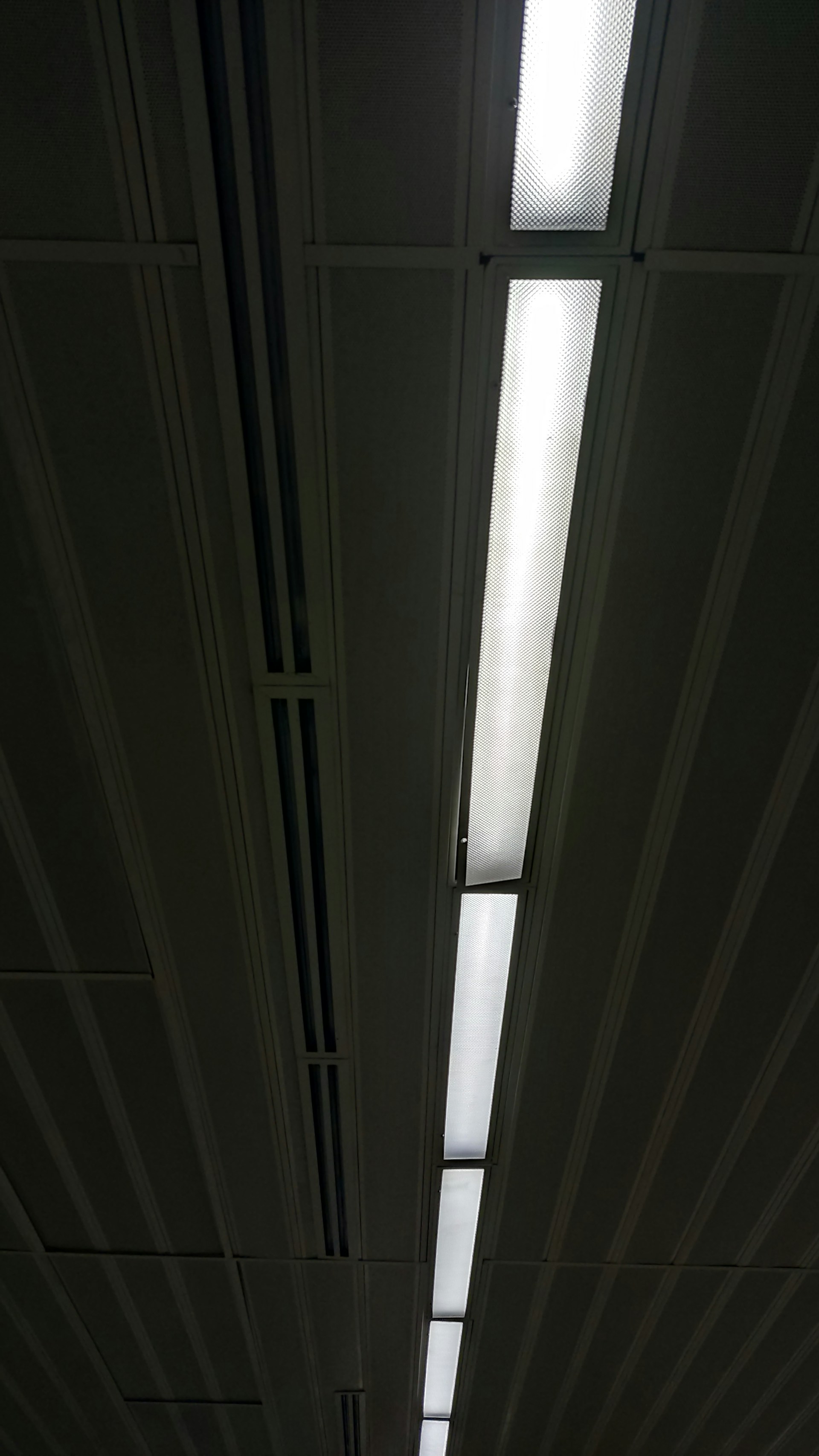 a long hallway with a skylight above it