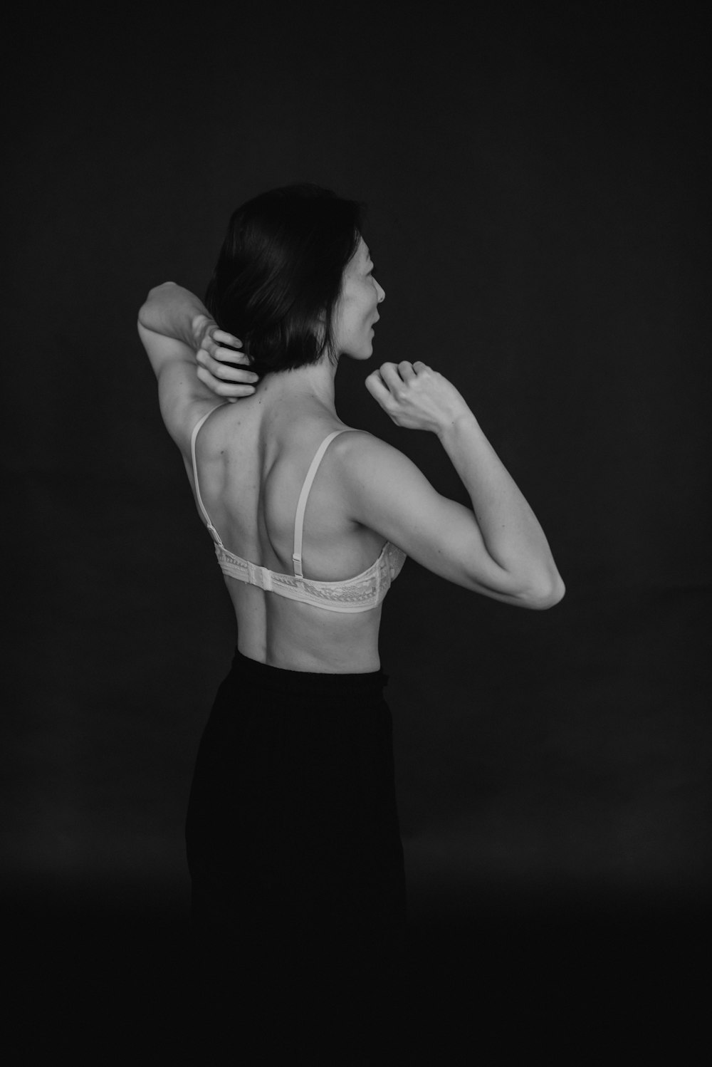 a woman wearing a bra in a black and white photo