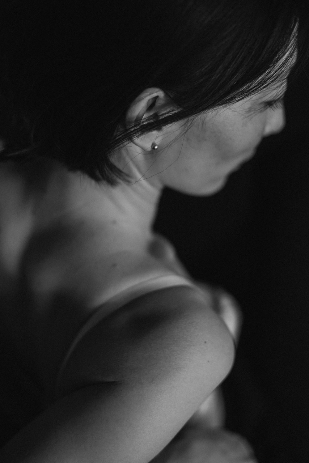 a black and white photo of a woman's shoulder
