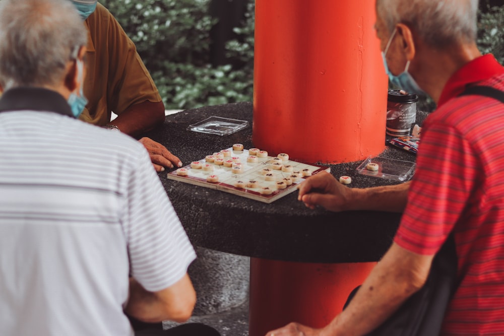 a group of people playing a game of chess