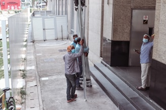 a group of people standing on the side of a building