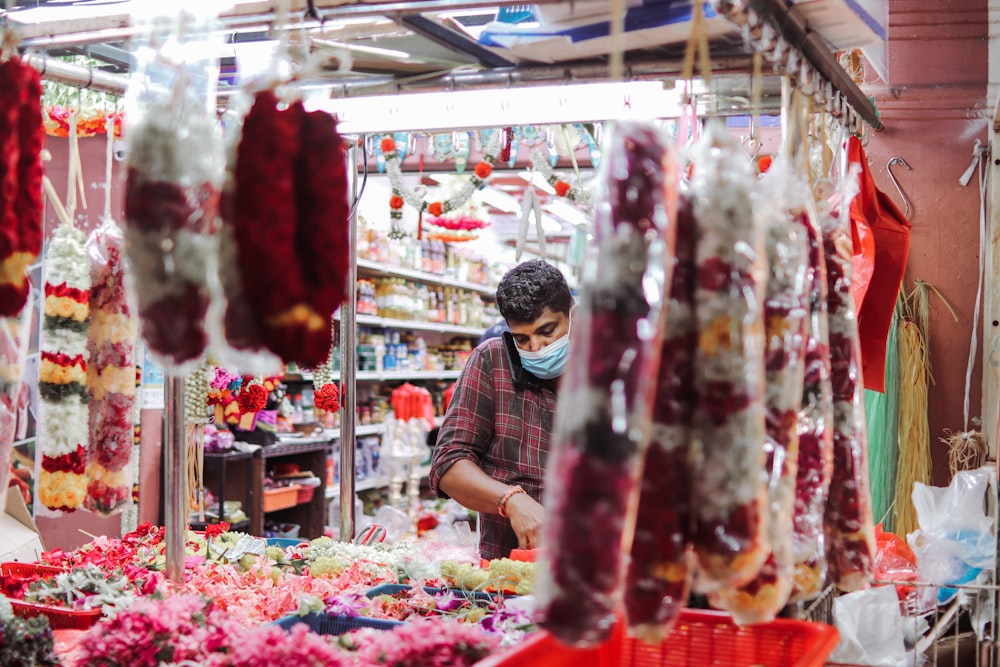 a man wearing a face mask in a market