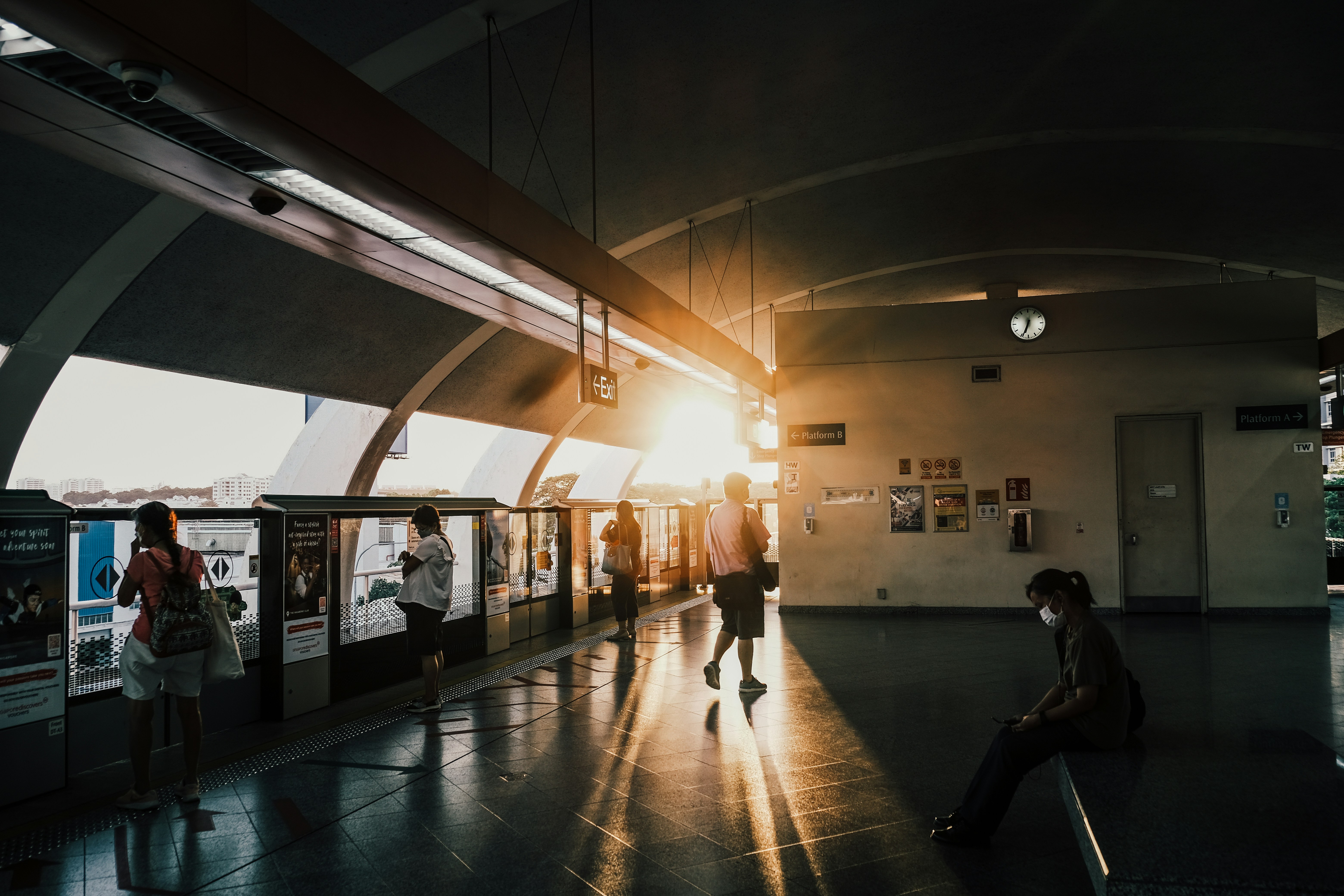 a group of people standing around a train station, Singapore Tampines MRT station open air view