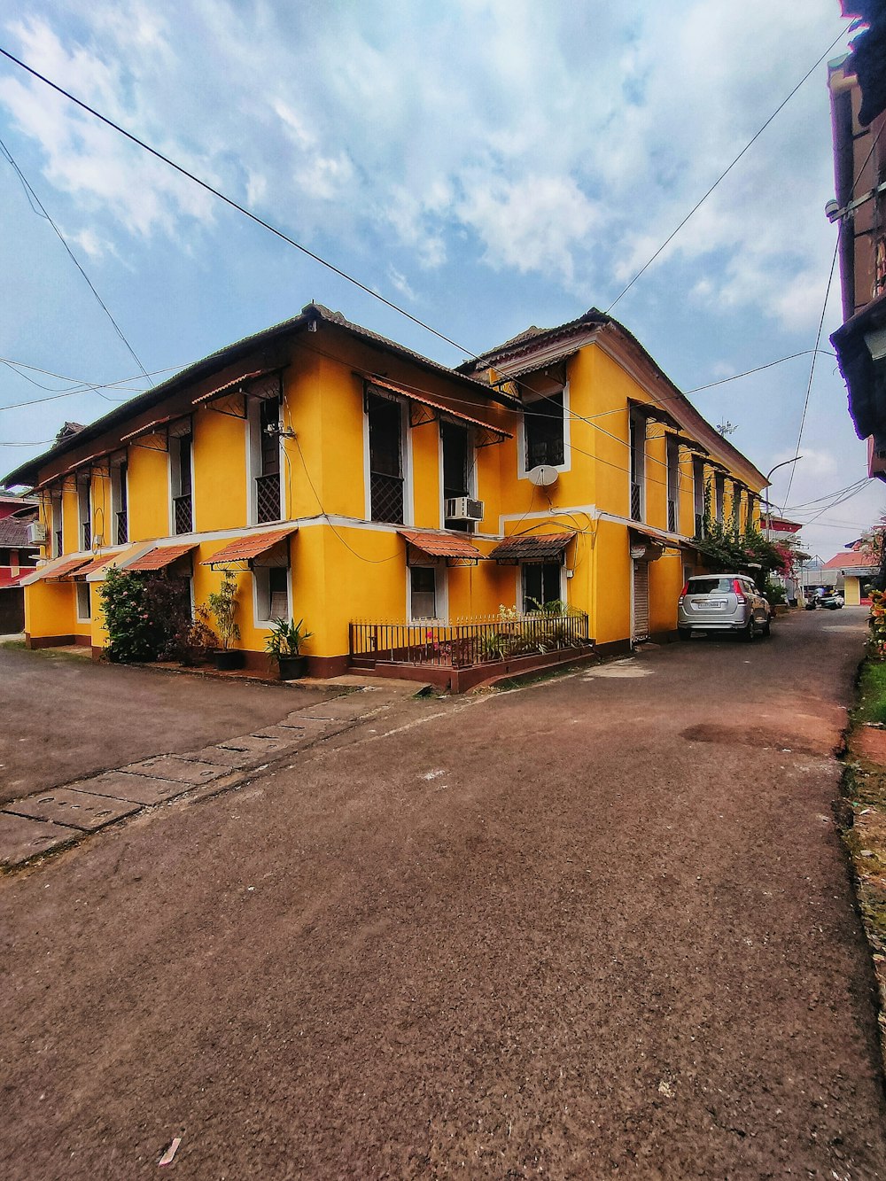 a yellow building sitting on the side of a road