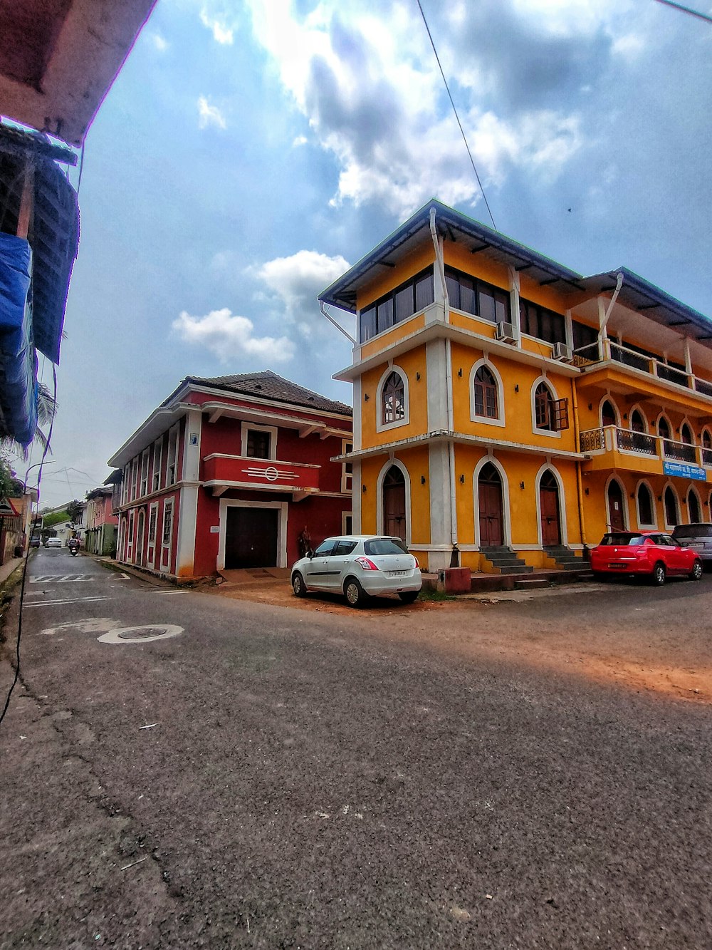 a large yellow building with cars parked in front of it