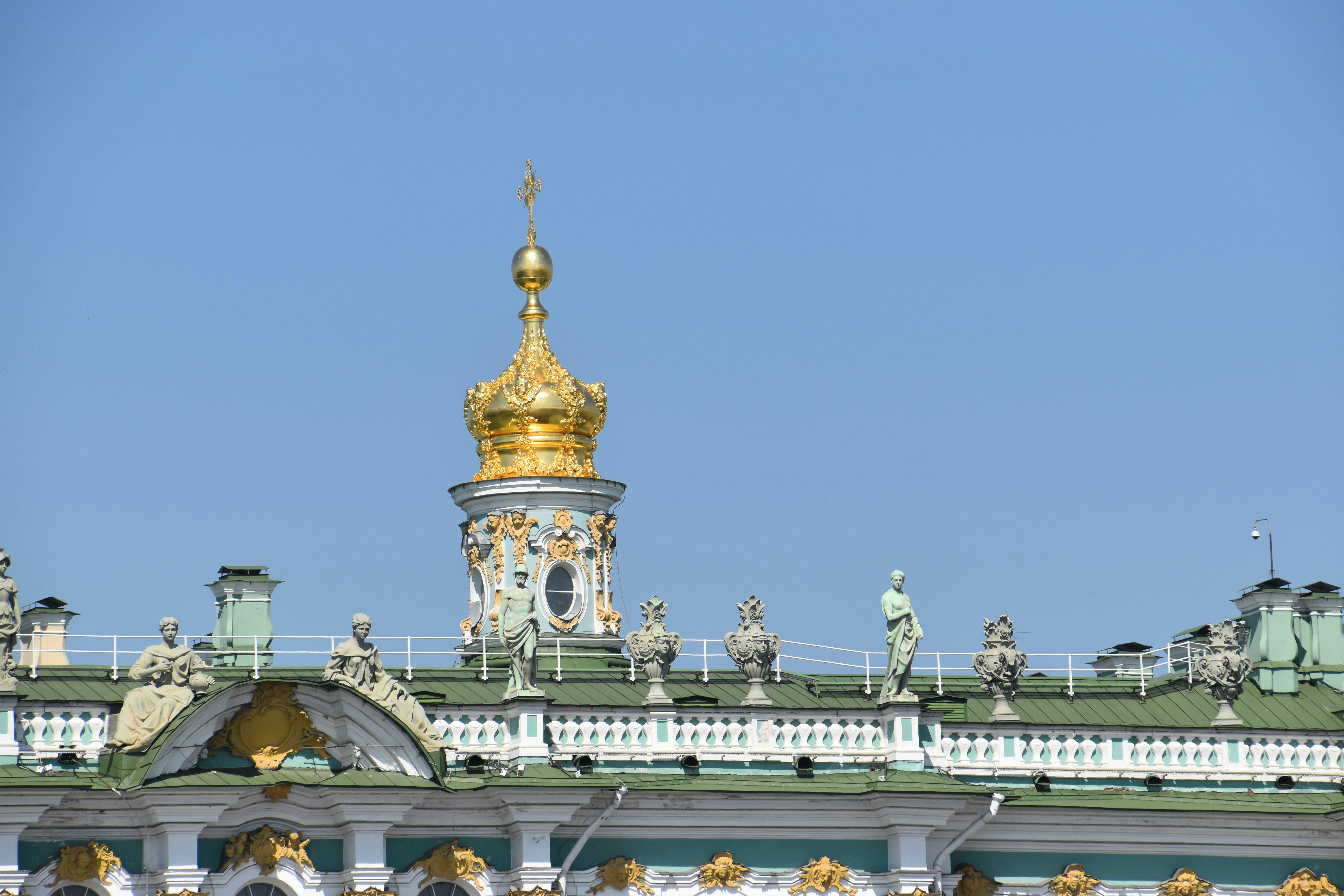a gold and white building with a clock tower