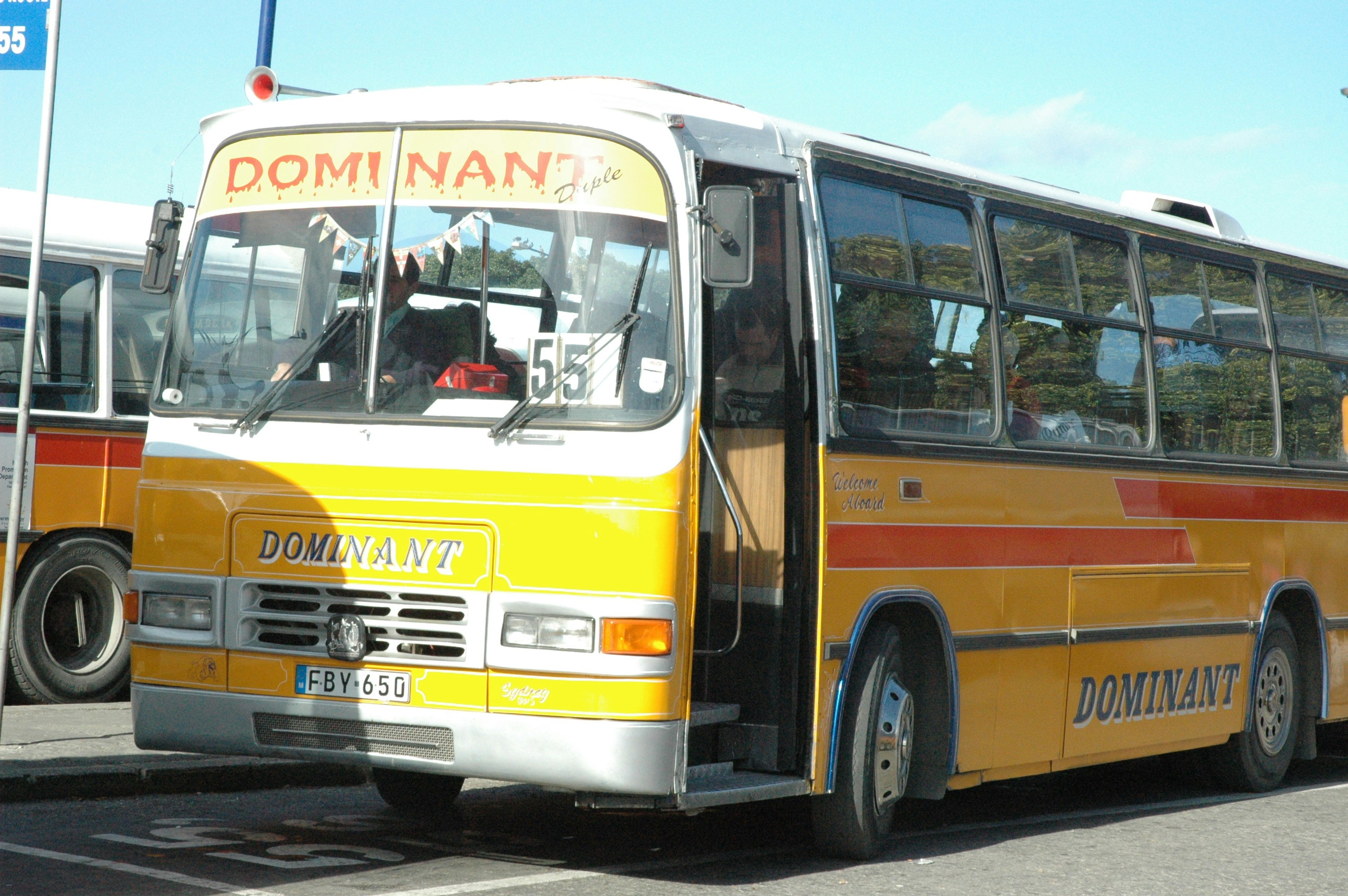 a yellow and red bus driving down a street