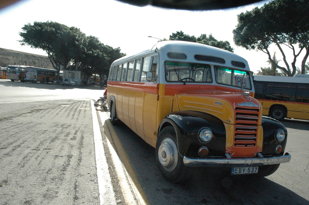 an old bus is parked on the side of the road
