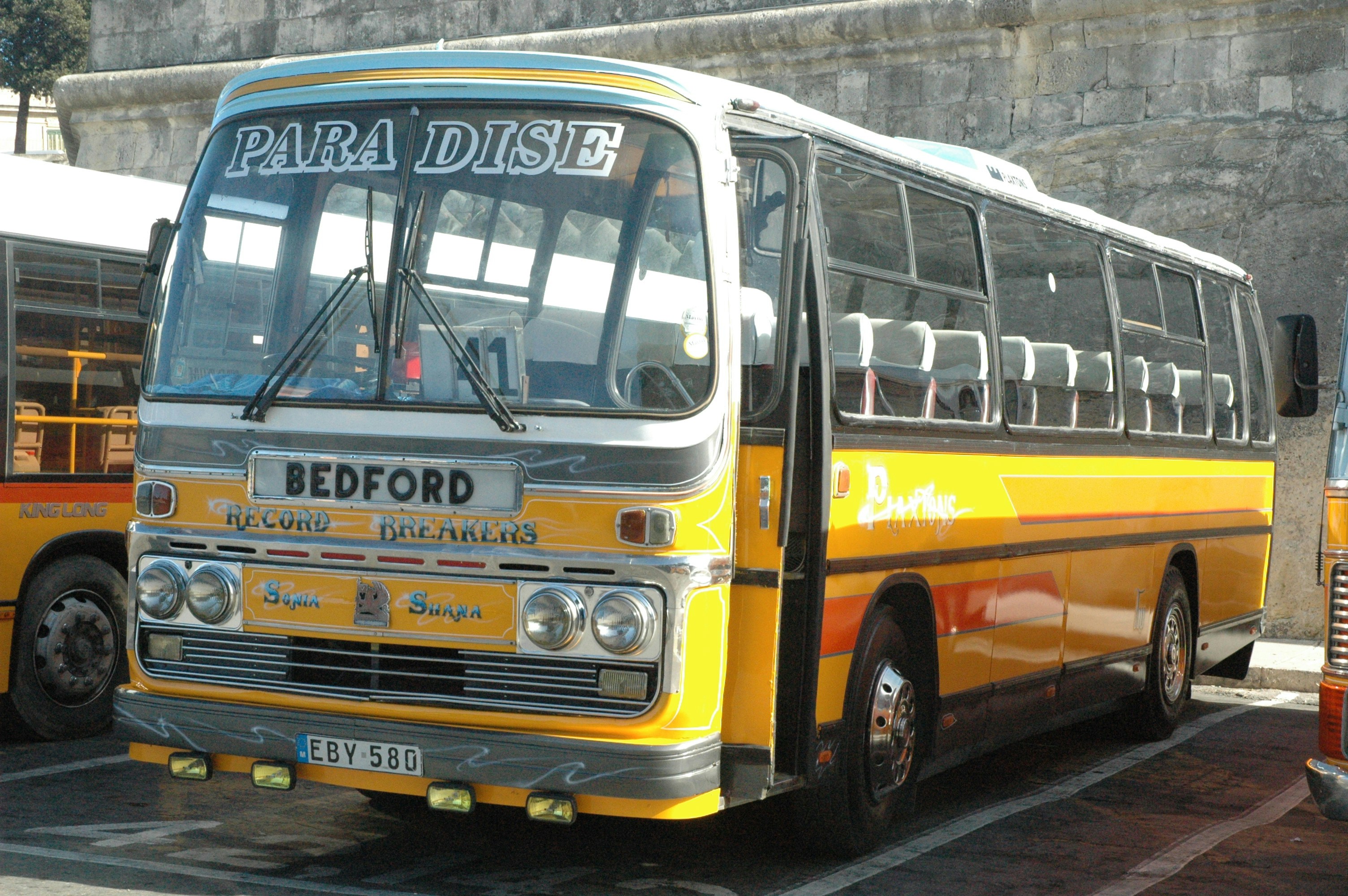 a yellow bus parked in a parking lot