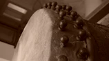 Close-up of a skilled artisan shaping the wooden frame of a mandar drum with traditional tools