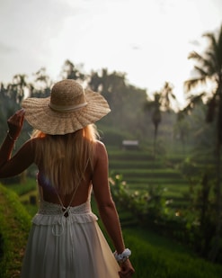 a woman in a white dress and a straw hat