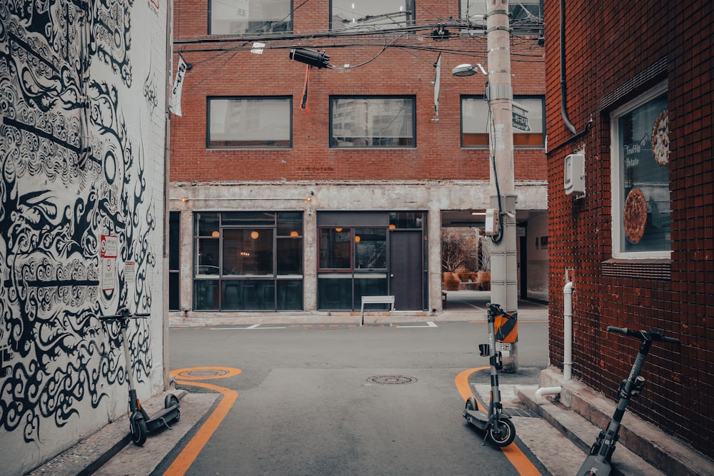 an alley way with scooters parked on the side of it