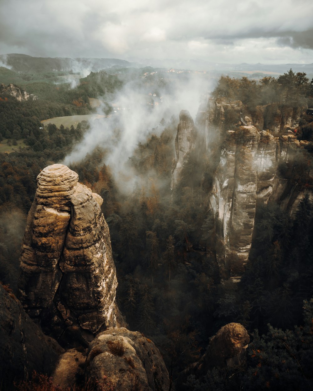 a view of a mountain range with a foggy sky