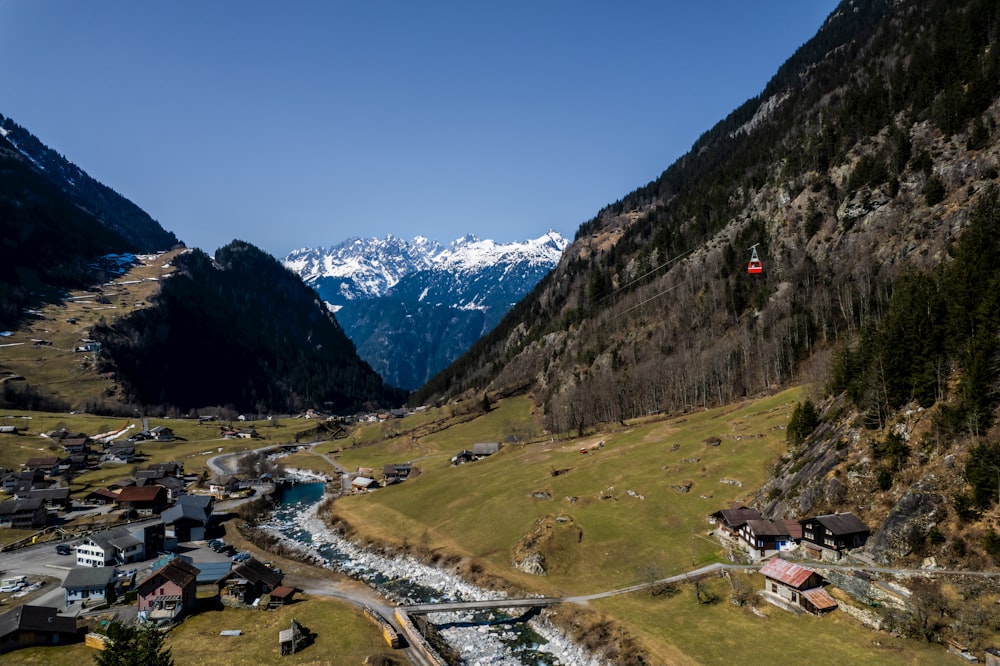 a scenic view of a valley with a mountain in the background