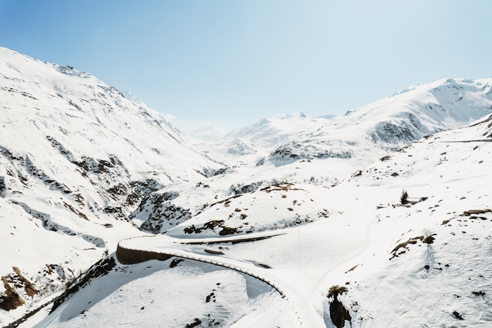 a snow covered mountain with a road going through it