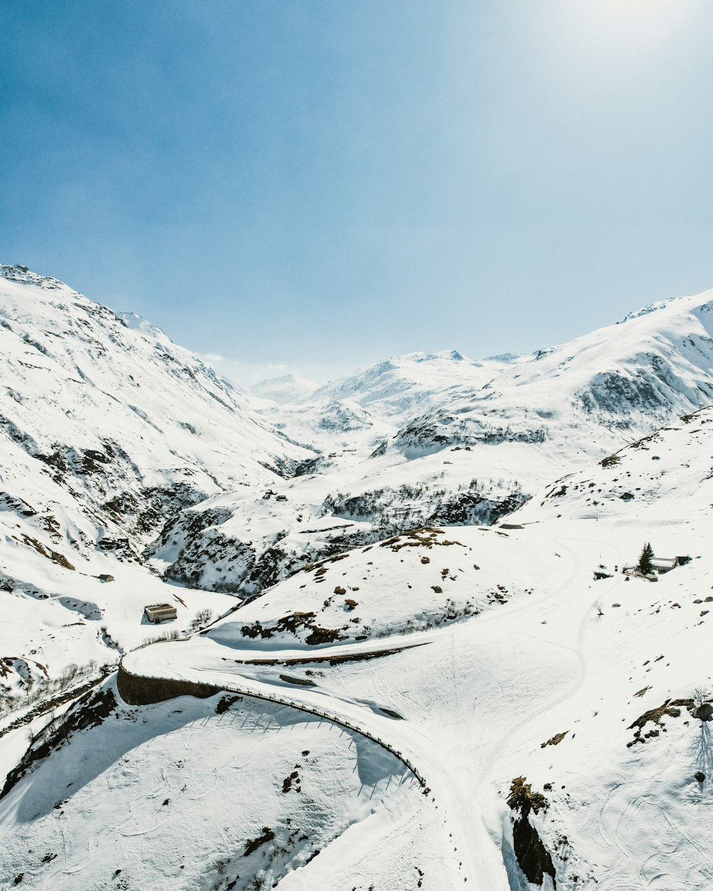 a person riding skis on top of a snow covered slope