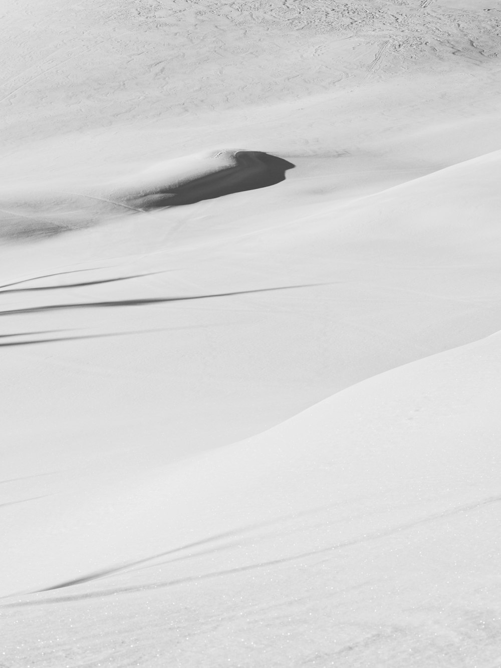 a man riding skis down a snow covered slope