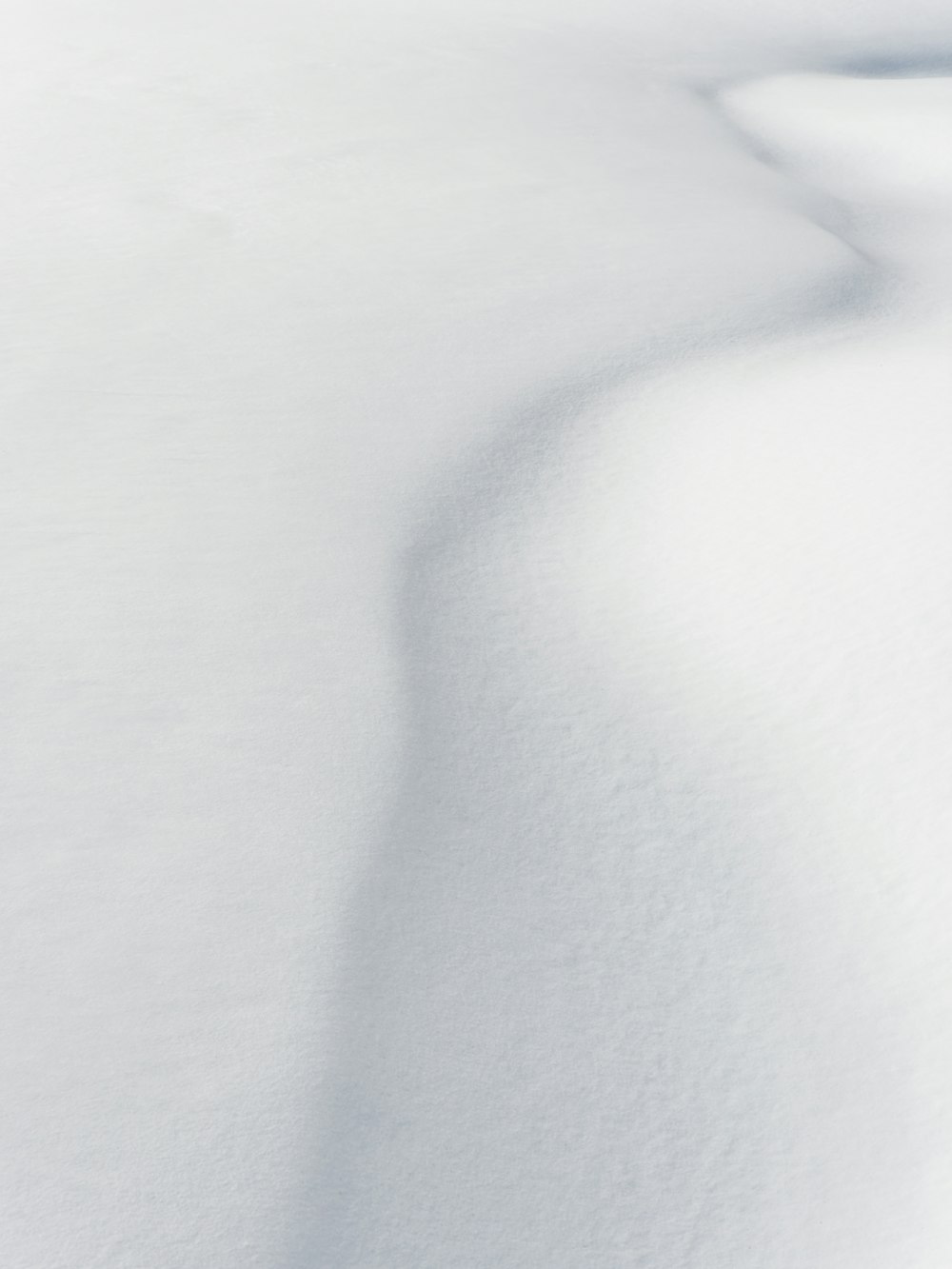 a man riding skis down a snow covered slope