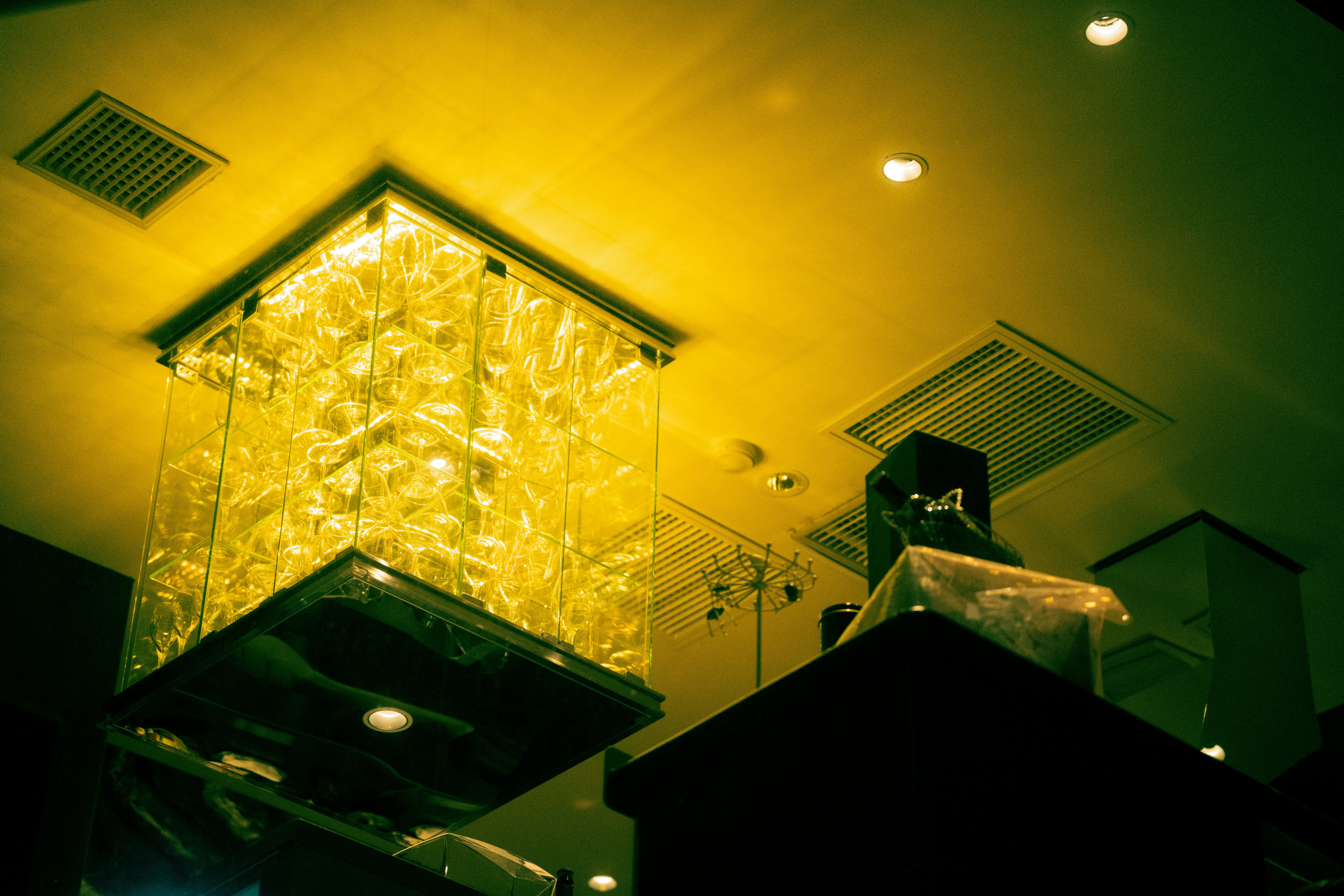 a yellow light shines on the ceiling of a room