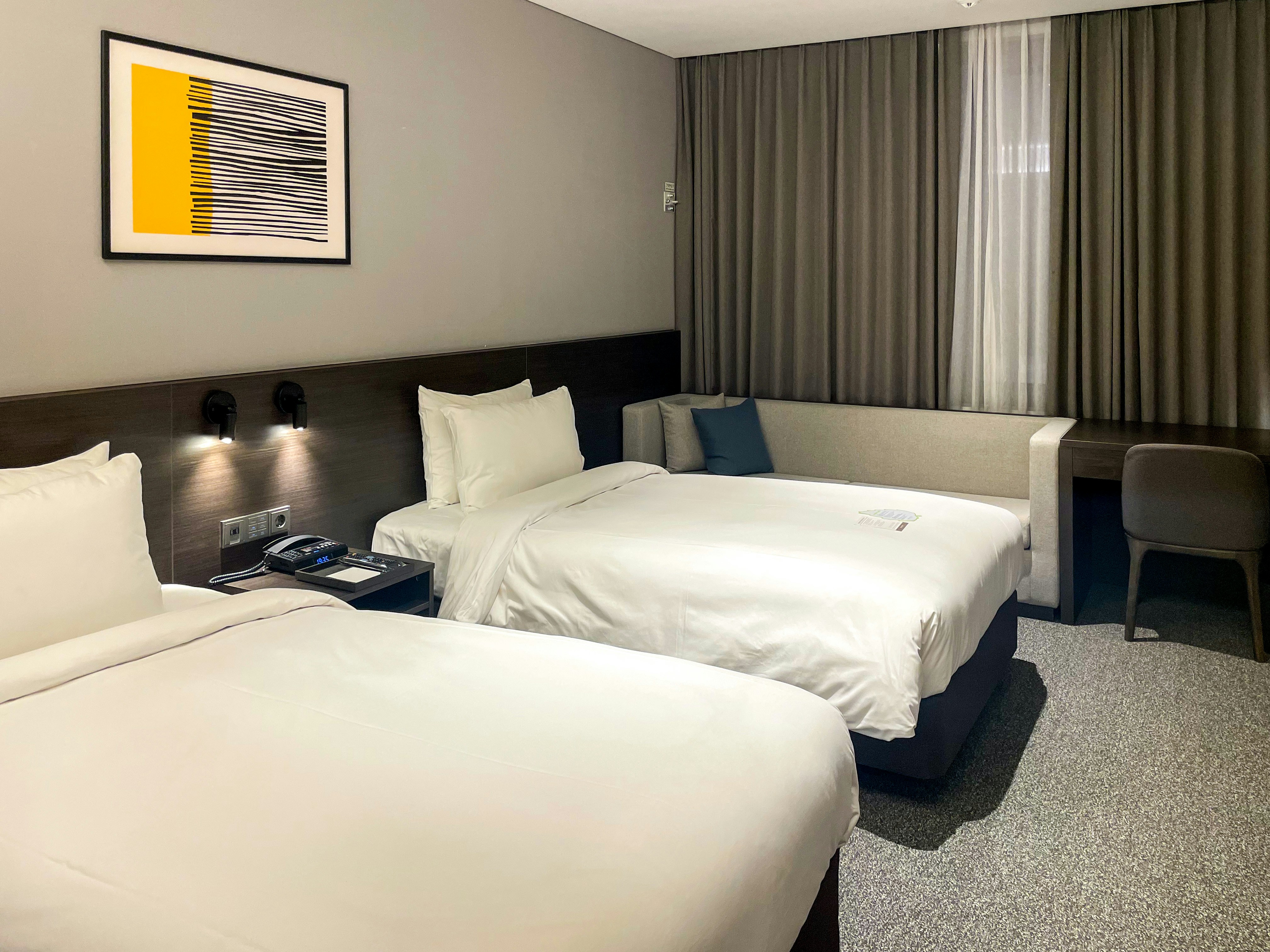 a hotel room with two beds and a desk