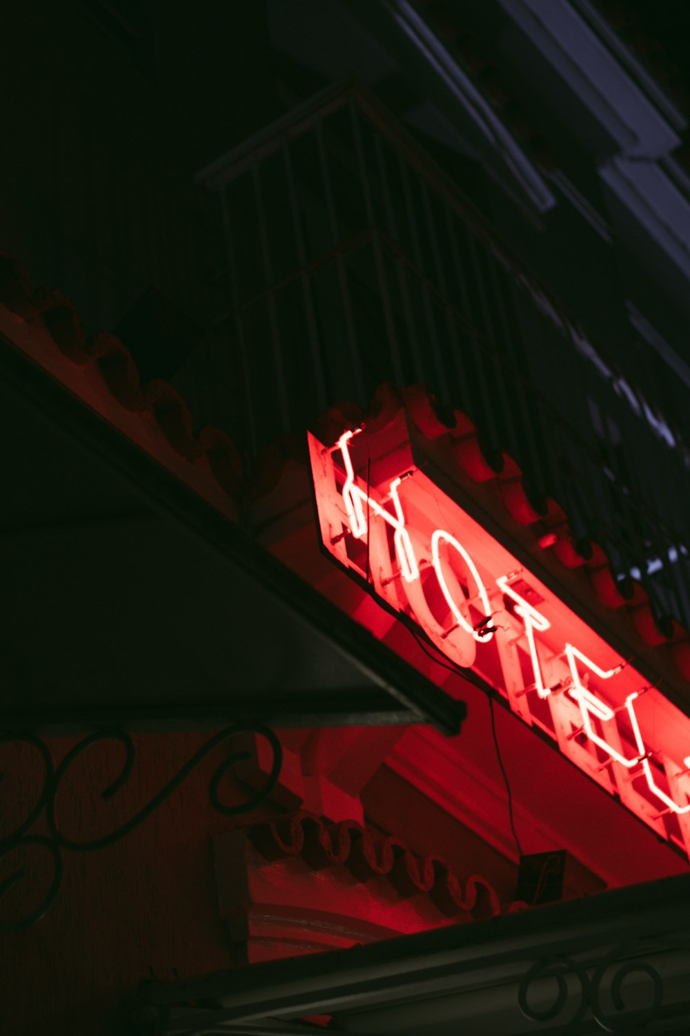 a red neon sign that reads hotel