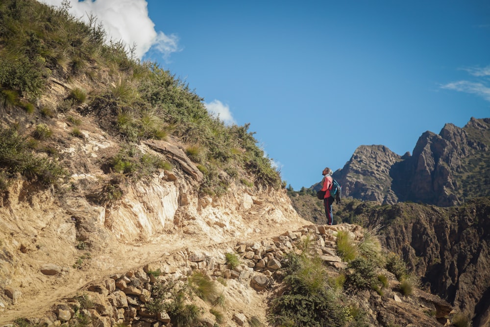 a man standing on top of a rocky cliff