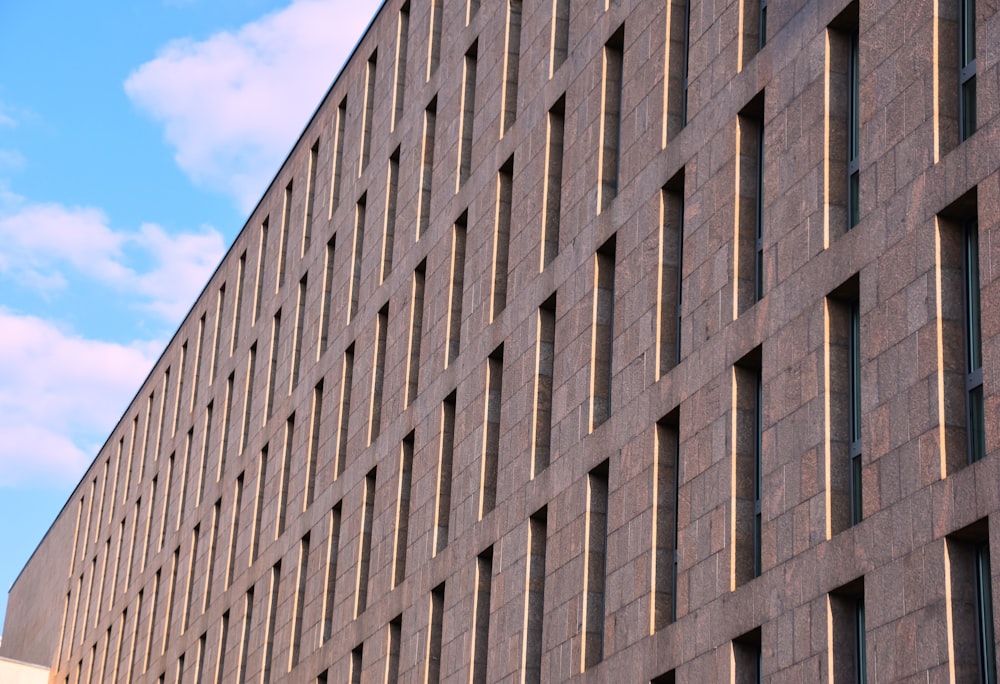 a tall brick building with many windows on the side of it