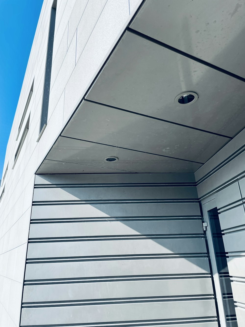 a closed garage door with a blue sky in the background