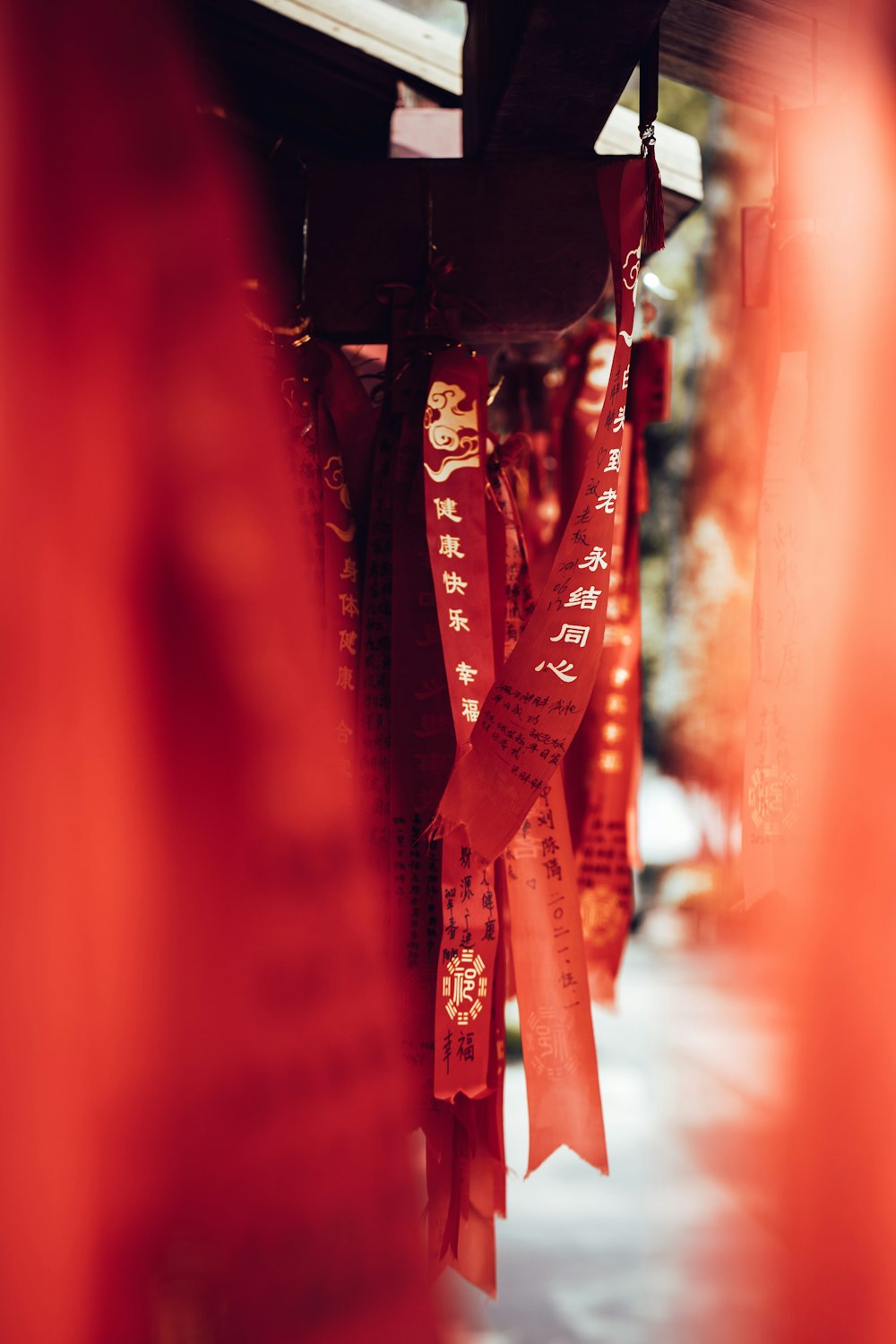 a row of red ribbons hanging from the ceiling
