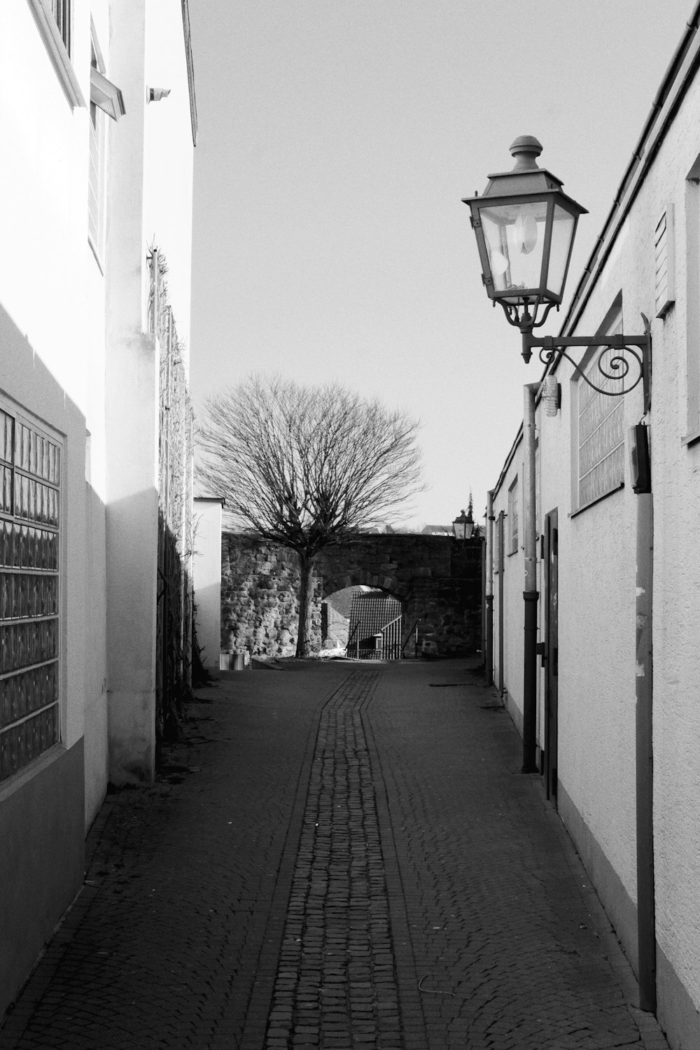 a black and white photo of a cobblestone street