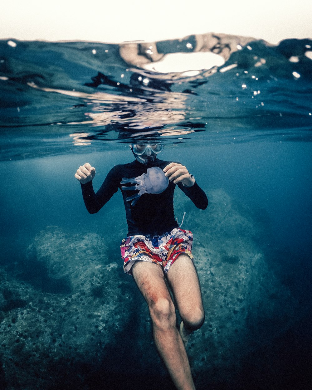 a woman swimming in the ocean with a mask on