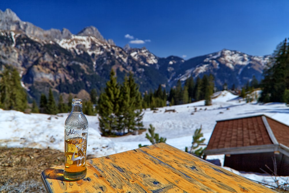 a bottle of beer sitting on top of a wooden table