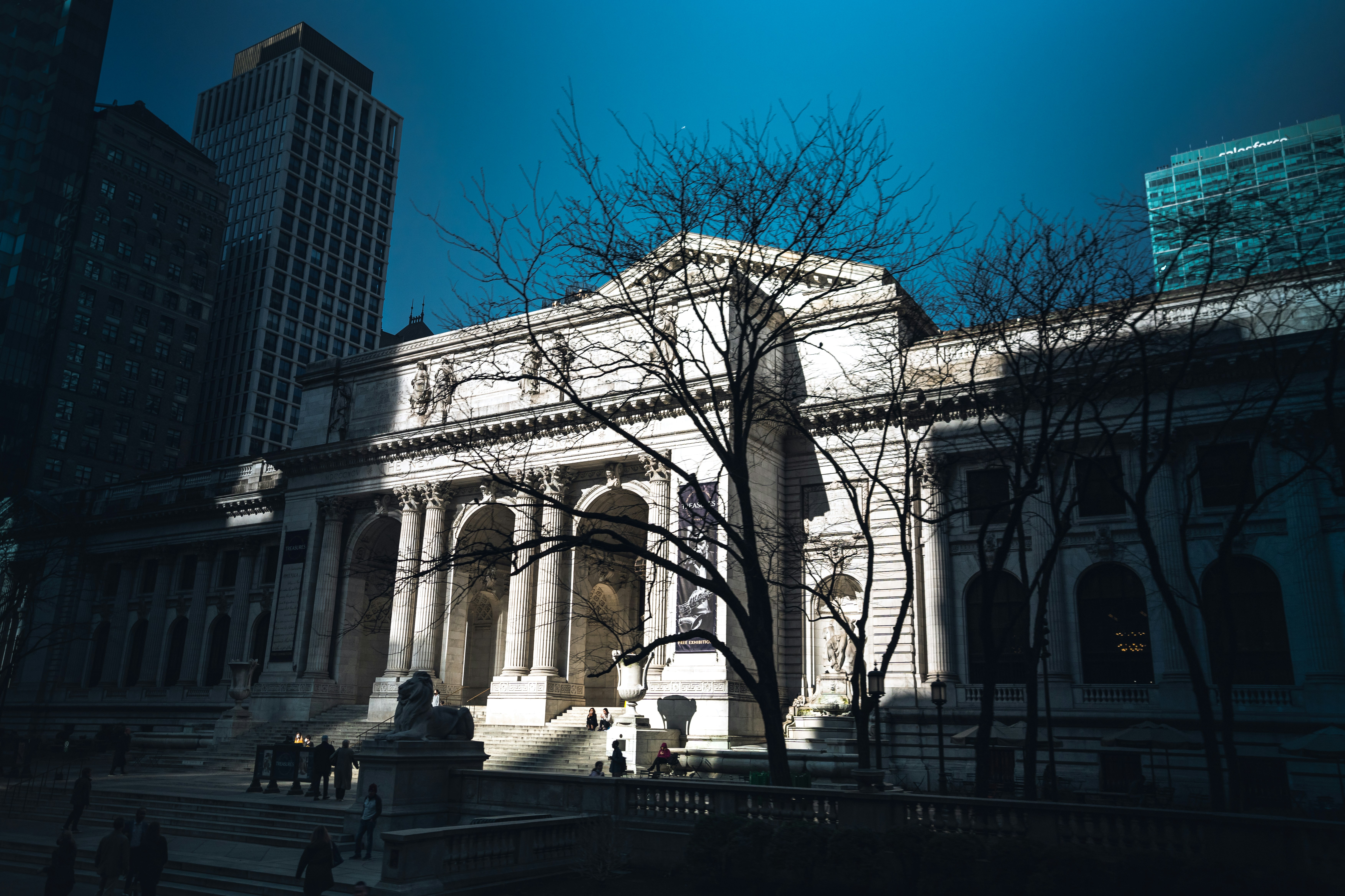a large building with a tree in front of it, 